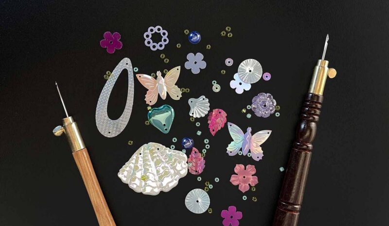 tambour hooks and sequins on chalkboard