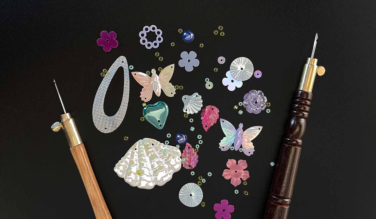 tambour hooks and sequins on chalkboard