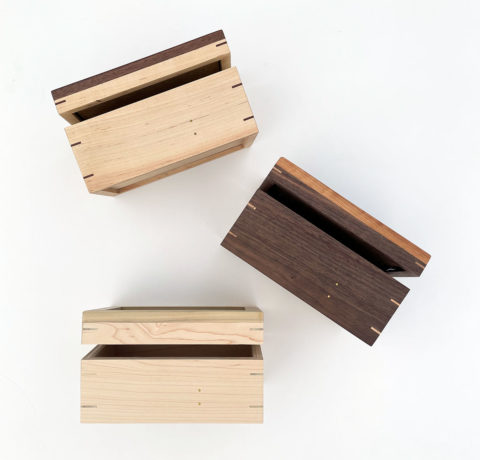 three wooden keepsake boxes shown from the front with their hinged lids slightly ajar