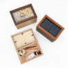 three wooden needlework keepsake boxes with frame lids, one of which is propped open to revealed divided interior compartments