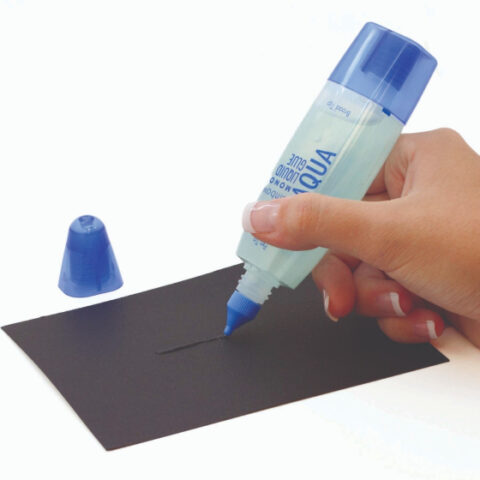 a hand applying clear glue with a fine tip to a sheet of black paper
